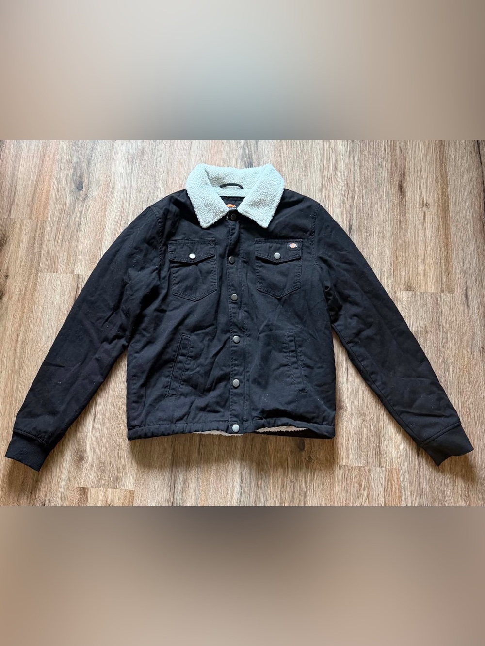 Dickies jacket features a soft, white sherpa-lined collar.